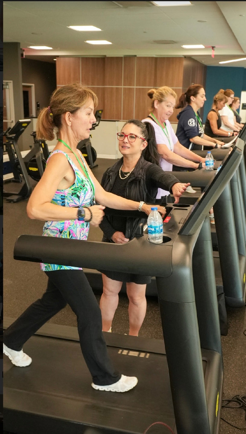 Dr. Vonda training with women on treadmills